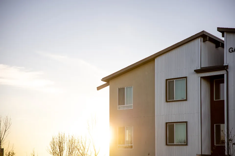 Two story home with lap siding at sunset